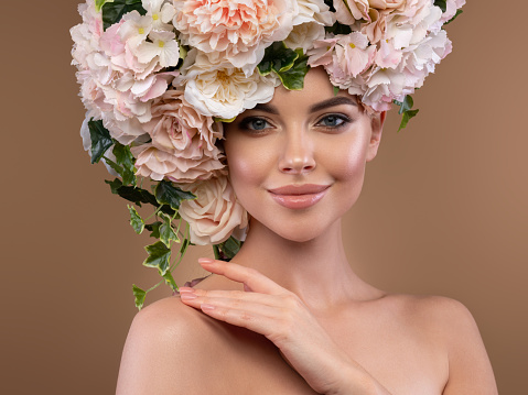 Young beautiful girl with wreath of flowers on her head