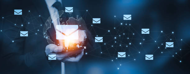 istock Businessman hand pressing smartphone for sending the e-mail from the laptop computer, Email and SMS marketing concept. Scheme of direct sales in business. List of clients for mailing. 1498726904