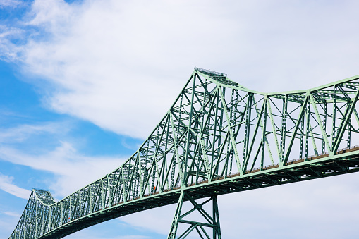 The Astoria–Megler Bridge,  a four mile steel cantilever truss bridge spanning the lower Columbia river from Washington state to Oregon, USA.