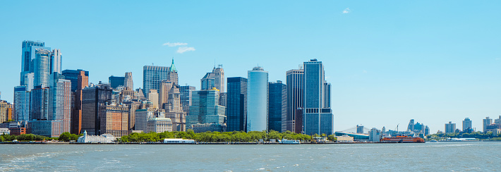 the Financial District and Lower Manhattan, in New York City, United States, since the Hudson River, on a spring day, in a panoramic format to use as web banner