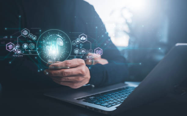 istock Businessman holding glowing light bulb with AI Data Management System on the computer, Hands working on a laptop cloud network graphic overlay, connected to the database. Corporate strategy finance 1498729746
