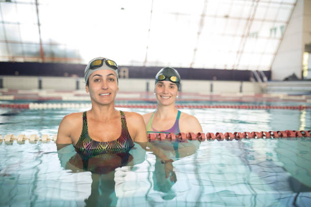 istock Smiling women inside a semi olympic pool 1498730942