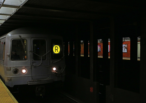 New York, October 13 2014: subway R Broadway Local arrival to the station. it is a rapid transit service in the B Division of the New York City Subway