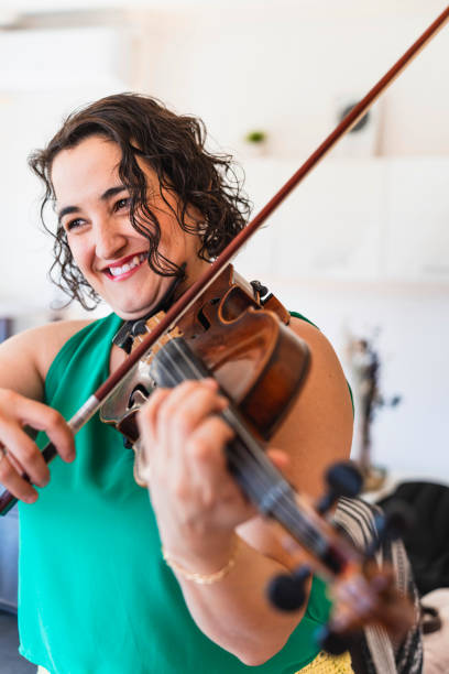 istock Elegant Melodies: Accomplished Violinist Showcasing Musical Artistry at Home 1498734539