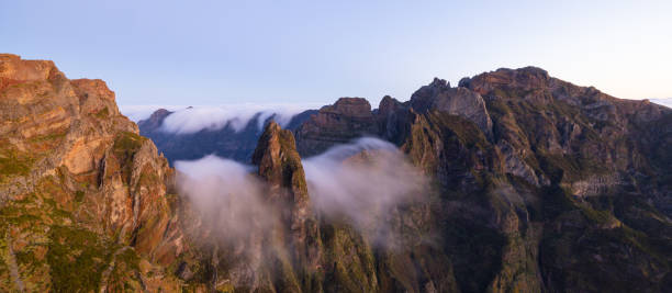 Title cover of Pico Ruivo on Madeira at a sunset with fog. Perfect size for banner or wallpaper. stock photo