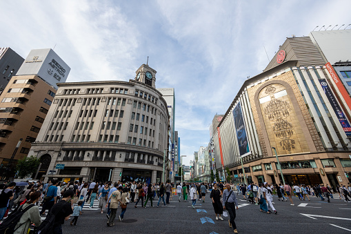 Tokyo, Japan - May 27, 2023 : Pedestrians at the Ginza 4-Chome in Tokyo, Japan. Ginza is a popular upscale shopping area of Tokyo.