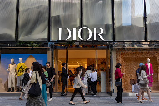 Tokyo, Japan - May 27, 2023 : Pedestrians walk past the Christian Dior's shop at the Ginza shopping district in Tokyo, Japan.