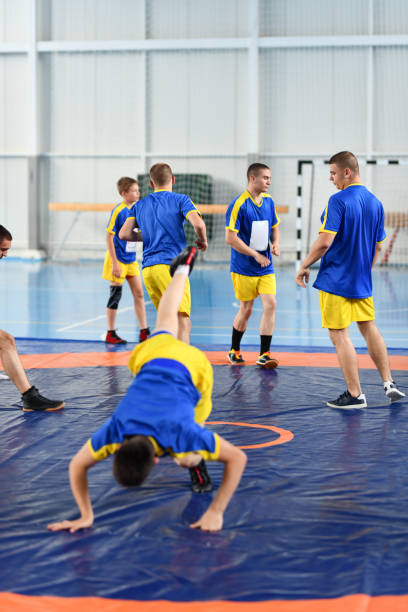 istock Different Gymnastic Exercises By Wrestlers In Gym 1498741487