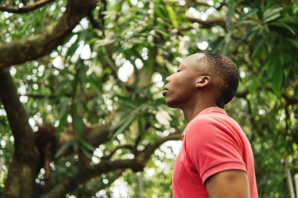 istock Young man breathing deep fresh air outdoor. 1498743225