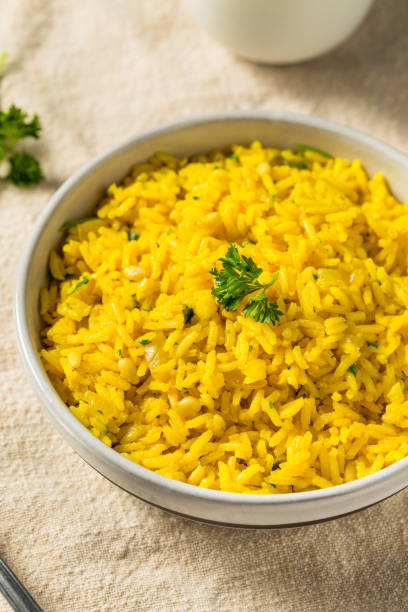 Homemade Yellow Mediterranean Rice Homemade Yellow Mediterranean Rice with Pine Nuts basmati rice stock pictures, royalty-free photos & images