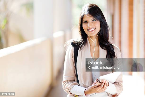 Female University Student Using Tablet Computer Listening Music Stock Photo - Download Image Now