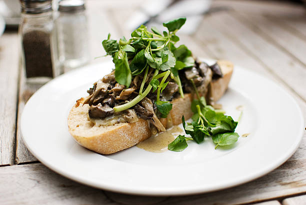 delicious mushrooms and green herb over slice of bread
