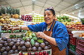 Portrait of a senior female retail clerk working at a greengrocer's shop