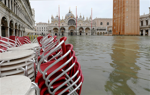 high tide in Venice in northern Italy and Square of San Marco completely flooded and the chairs of the outdoor cafes piled up