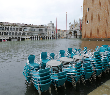 high tide in Venice in northern Italy and Saint Mark Square flooded and the chairs of the outdoor cafes piled up