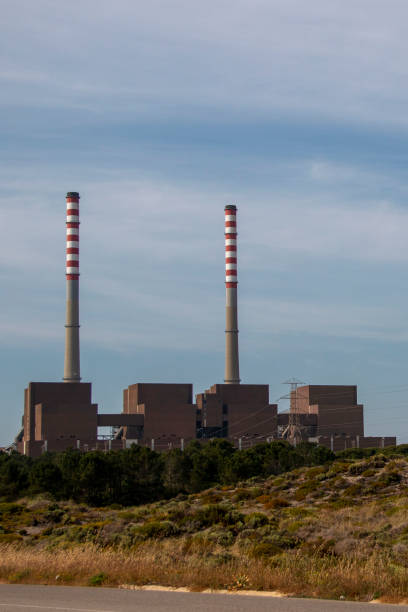 istock Factory producing electricity with two huge chimneys 1498754658