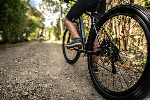 Close-up of a bicycle wheel in a trail