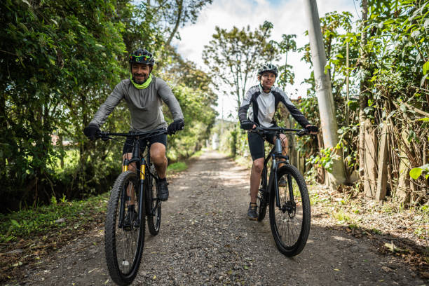 istock Father and son cycling in a trail 1498754689