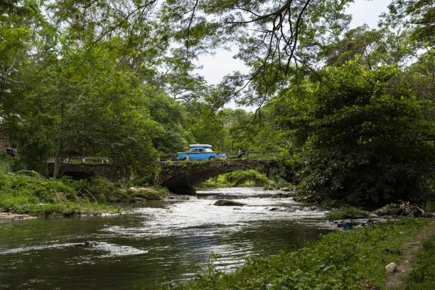 Cuba, Havana, December 10, 2017: A car drives over a bridge in a park in Havana.