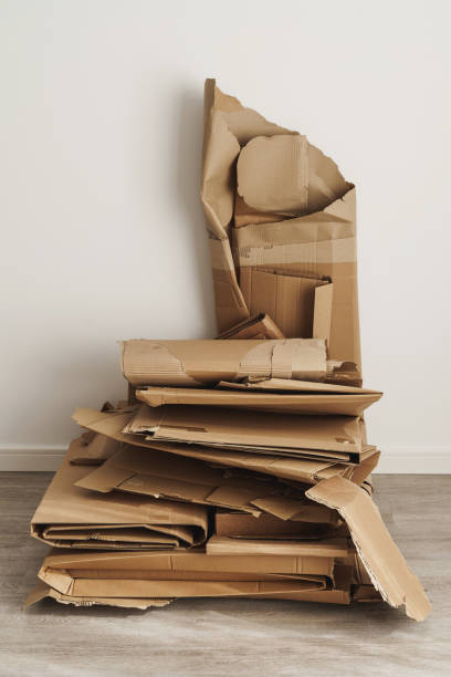 istock Stack of Cardboard Waste at home. Concepts of Paper Recycling and Waste Sorting 1498756829