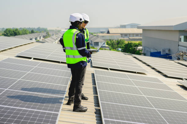 istock Engineers with safety helmet checking solar system at solar power farm 1498758233