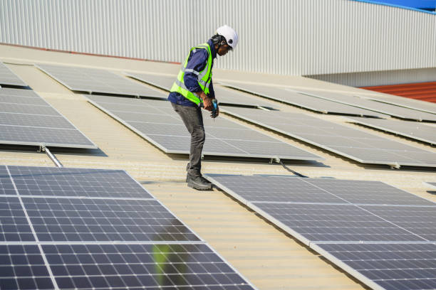 istock Engineers with safety helmet checking solar system at solar power farm 1498758767