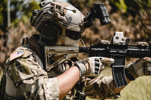 istock Soldier in protective combat uniform, Soldier with rifle in forest 1498759708