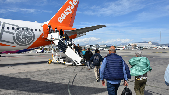 Nice, Côte D'Azur, France - April 25, 2023: People Boarding EasyJet Passengers Airplane At Nice Côte d'Azur Airport During Springtime