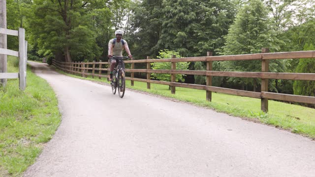 Mountain Biker Is Riding A Bicycle In The  Countryside