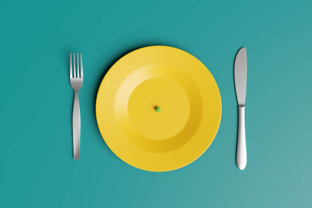 istock Yellow plate with only a green pea with fork and knife on each side on green background. Illustration of the concept of superfood, dieting, famine and green diet 1498761854