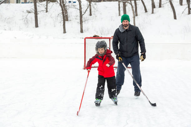Father & Son Practicing Hockey at Outdoor Rink
