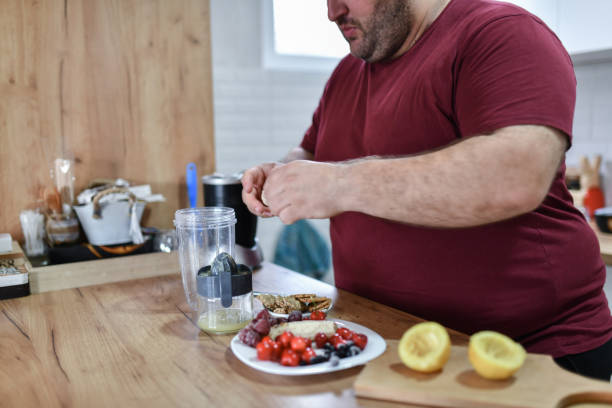 istock Overweight Male Adhering To New Weight Loss Program With Smoothie 1498770236