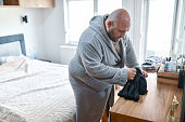 Overweight Male In Bathrobe Choosing Underwear