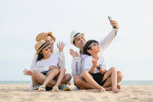 istock Happy family spending vacation time together on beach 1498770532