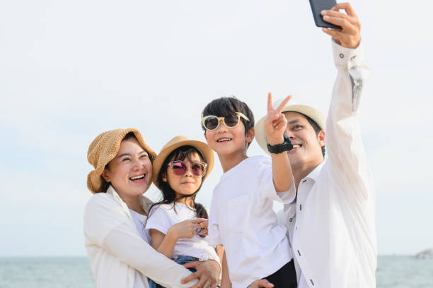 istock Happy family spending vacation time together on beach 1498770601