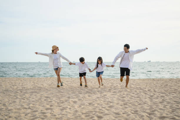 istock Happy family spending vacation time together on beach 1498770655