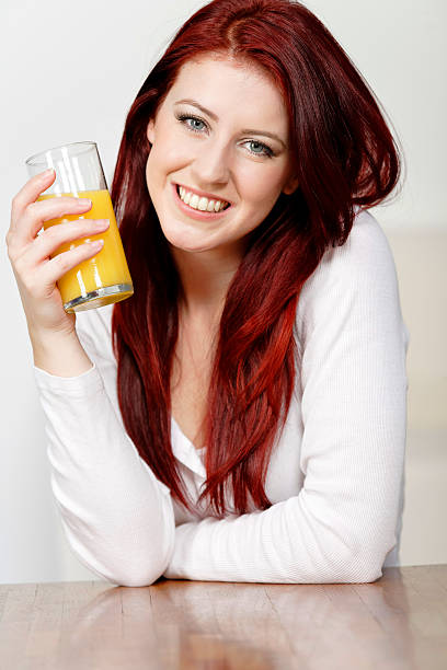 istock Happy woman with fresh Orange juice 149877090