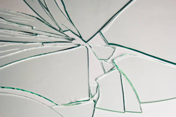 istock Broken glass pile pieces of texture and background isolated on white, cracked window effect. Emergency condition. 1498772275