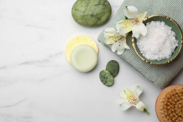 istock Flat lay composition with spa products and flowers on white marble table. Space for text 1498772468