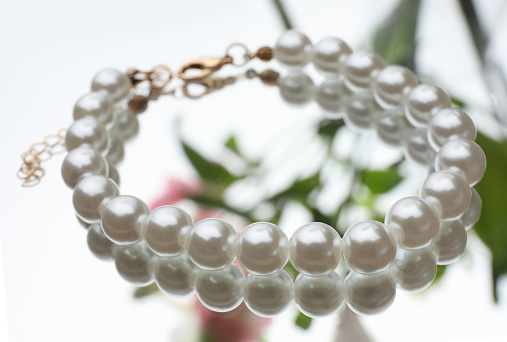 Elegant bracelet with pearls on mirror surface