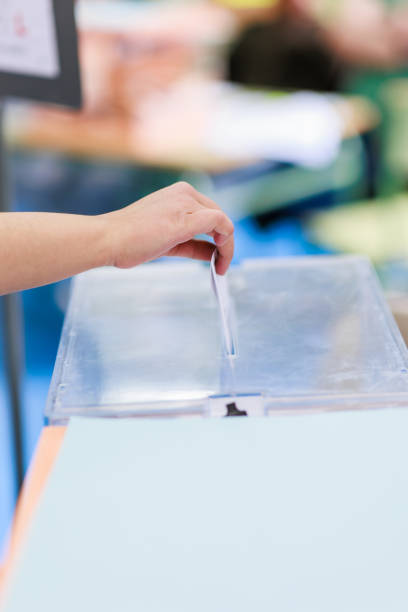 government democracy problems polling politics with envelop in ballot box. Gypsy citizen balloting in electoral college background with copy space