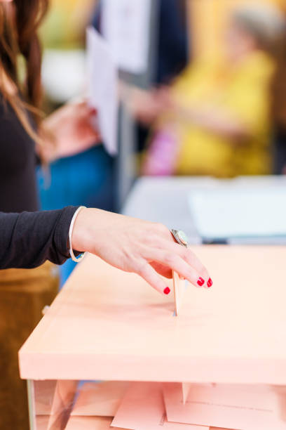 istock voting democracy background. Unrecognizable hispanic woman hand in candidate election referendum 1498775622