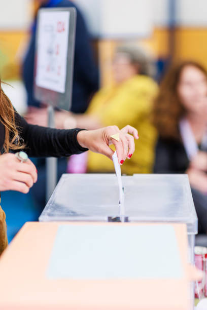 istock voting democracy background. Unrecognizable hispanic woman hand in candidate election referendum 1498776186