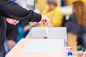 voting candidate campaign in democracy ballot box. Latin mid hand unrecognizable man