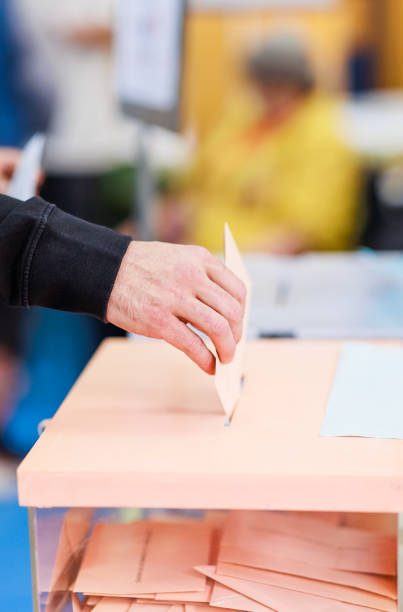 istock voting candidate campaign in democracy ballot box. Latin mid hand unrecognizable man 1498776462