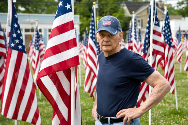 istock United States Veteran with American Flags 1498779713