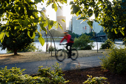 Motion blur of unrecognizable people riding bikes in the city. Shot in Downtown Portland Oregon, Pacific Northwest.