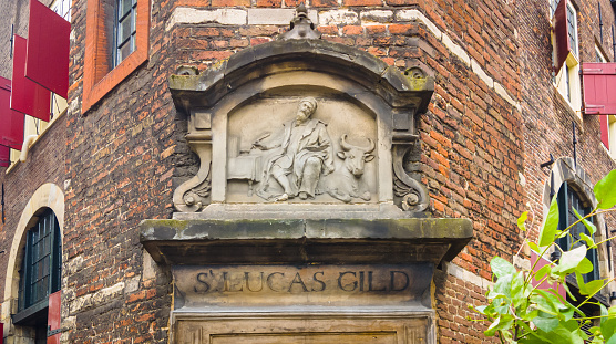 Close up of the gable stone for S. Lucas Gild on the Waag House in Amsterdam, The Netherlands. The S. Lucas Gild or Guild of Saint Luke was a city guild for painters, potters, stained glass craftsmen and other artists.