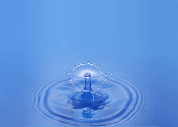 istock Drop of Water falling against Bleu background 1498780642
