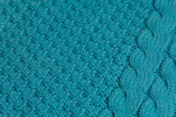 istock Pattern of colorful knitted sweaters closeup. Handmade merino wool product. Knitting patterns. 1498782958